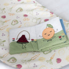 Folded children's book with cartoon characters on a fabric background