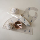 Children's tableware set with floral patterns on a white background