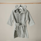 Gray hooded robe with a belt on a beige background