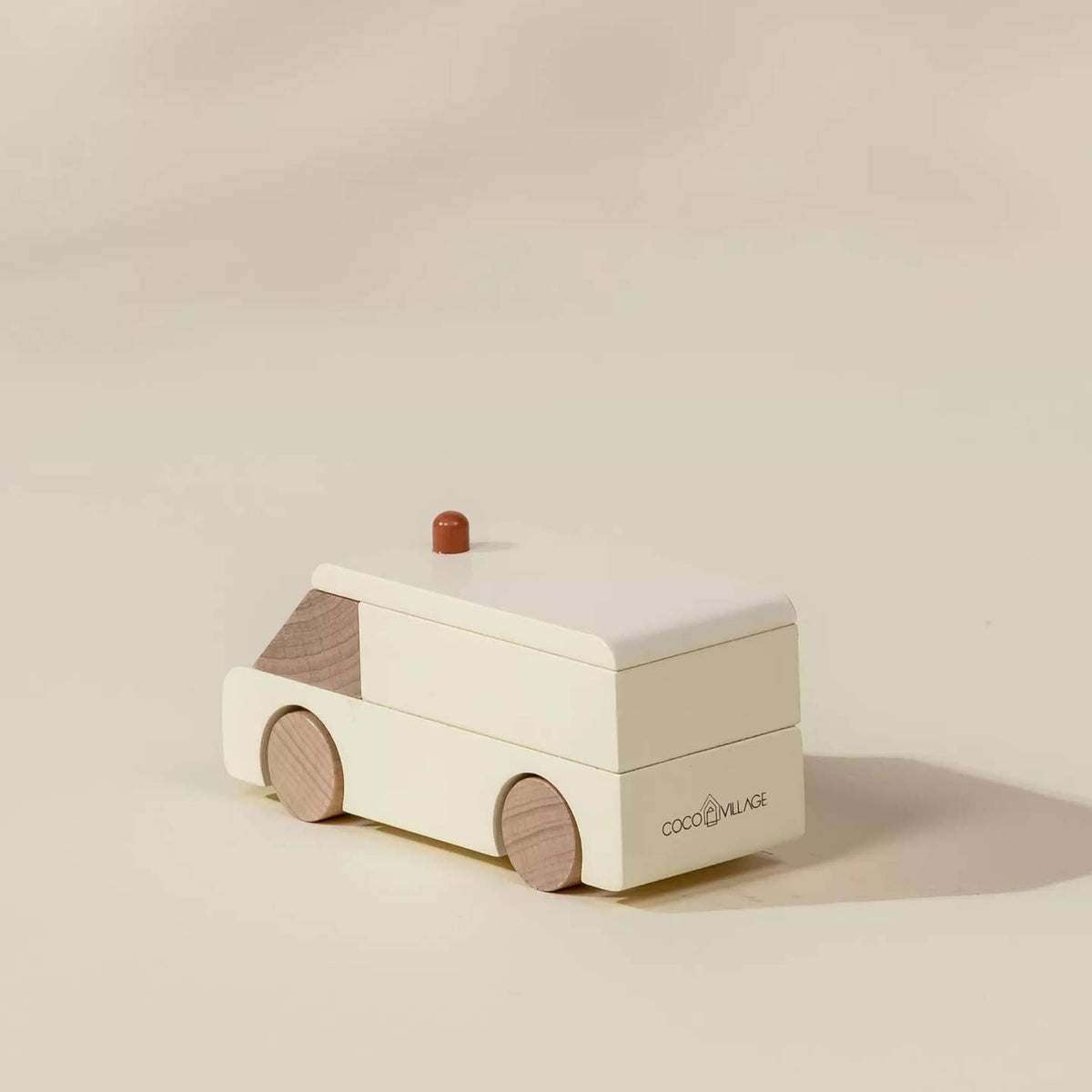 Wooden toy van with a small roof on a beige background