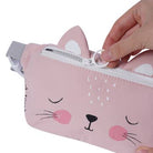 Pink cat-shaped pouch with a hand zipping it up on a white background