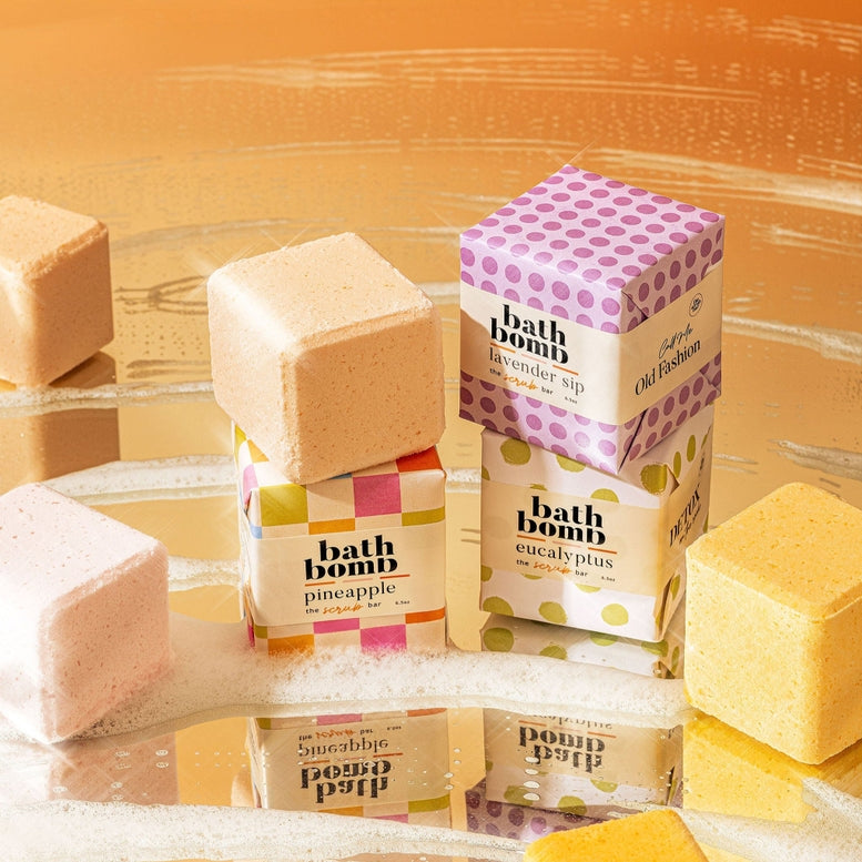 Collection of bath bombs with colorful packaging against a brown background