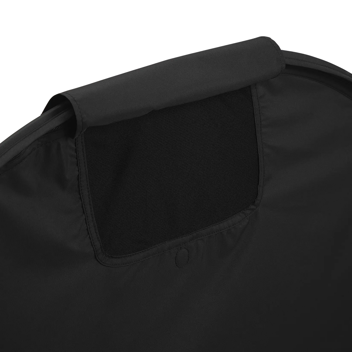 A close-up view of the peek-a-boo mesh opening on the black room-darkening canopy for the UPPAbaby Remi V2 playard against a dark checkered background.
