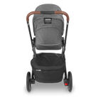 Gray stroller with brown handle on a white background