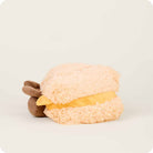 Plush toy resembling a sandwich with a bear character on a white background