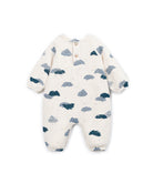 A baby long-sleeve footless one-piece romper in cream with a scattered cloud pattern in navy and slate blue, featuring a snap-button henley neckline.