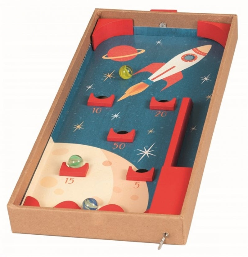 A children's wooden space-themed marbles game in a cardboard box, featuring a blue starry board with a rocket, planets, scoring holes, and red corner bumpers.