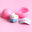Hello Kitty-themed product with pink lid and blue body on a pink background