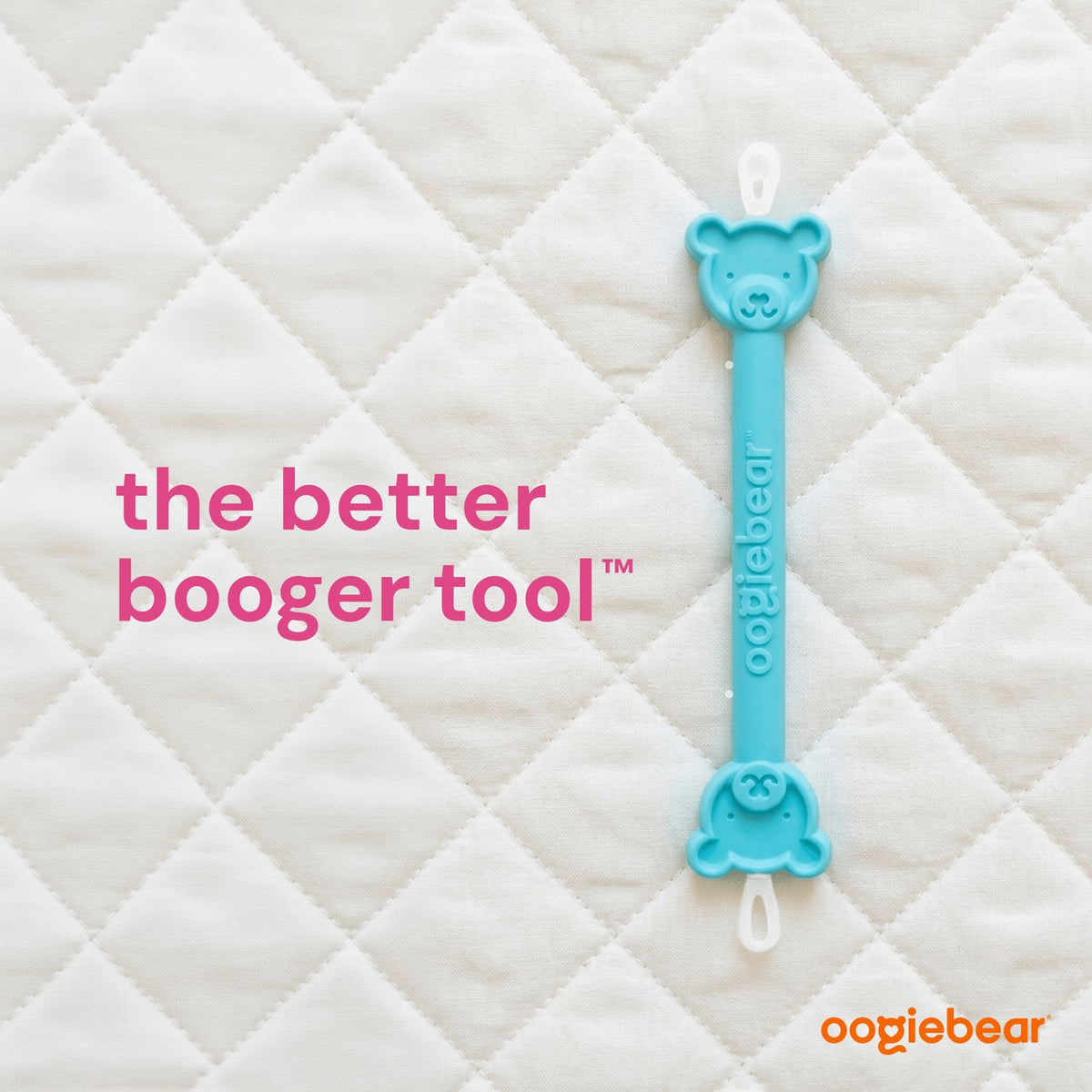 Blue booger removal tool with bear design on a quilted white background, featuring the brand 'oogiebear'.