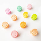 Colorful smiley face buttons on a white background
