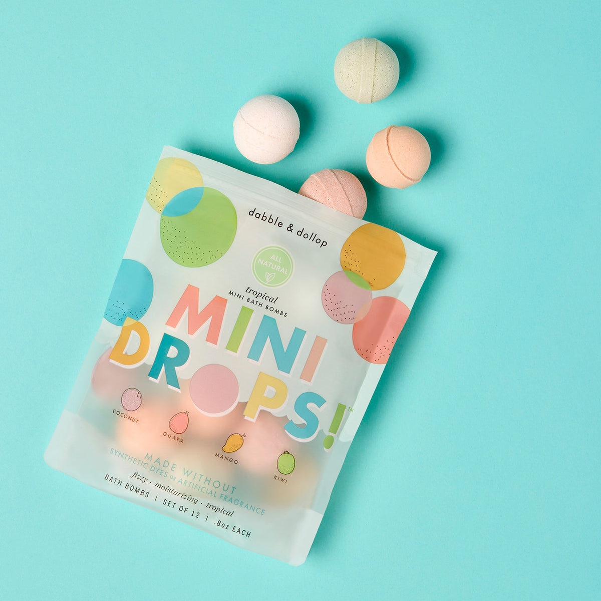 Package of dabble & dollop mini bath bombs on a light blue background