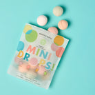 Package of dabble & dollop mini bath bombs on a light blue background