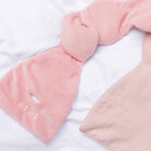 Pink plush neck pillow with 'Podpod' branding on a white background