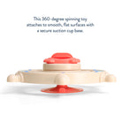 360-degree spinning toy with red top and beige base on a white background
