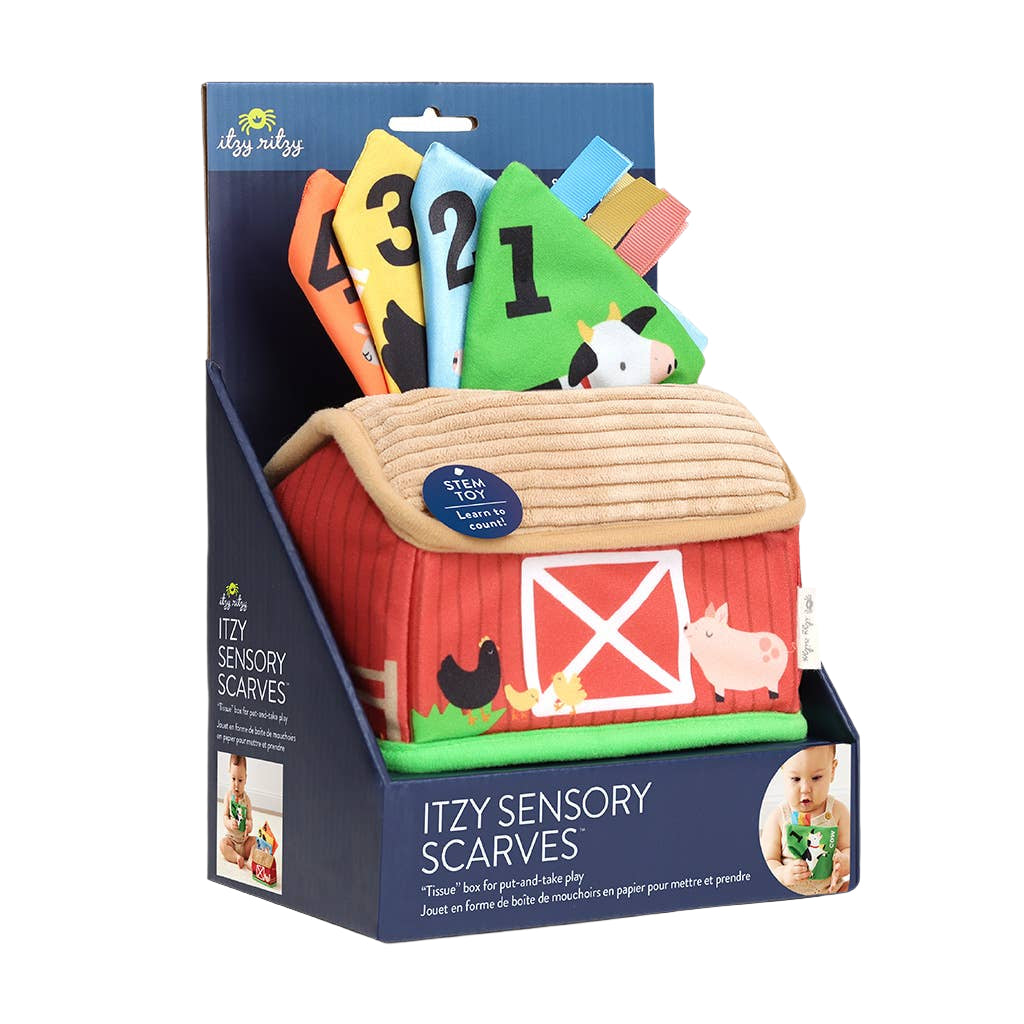 Itzy Sensory Scarves in a barn-shaped packaging display. The product includes four colorful paper scarves (numbered 4, 3, 2, 1) that pop out of a red barn house with a beige roof, shown in its retail packaging.