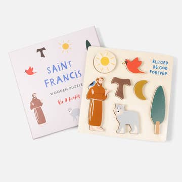 Wooden puzzle with Saint Francis design and packaging on a white background