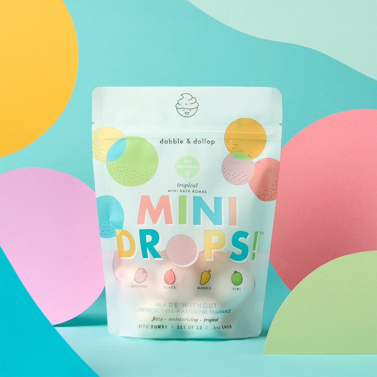 Packaging of 'Mini Drops' bath bombs with colorful design on a blue background