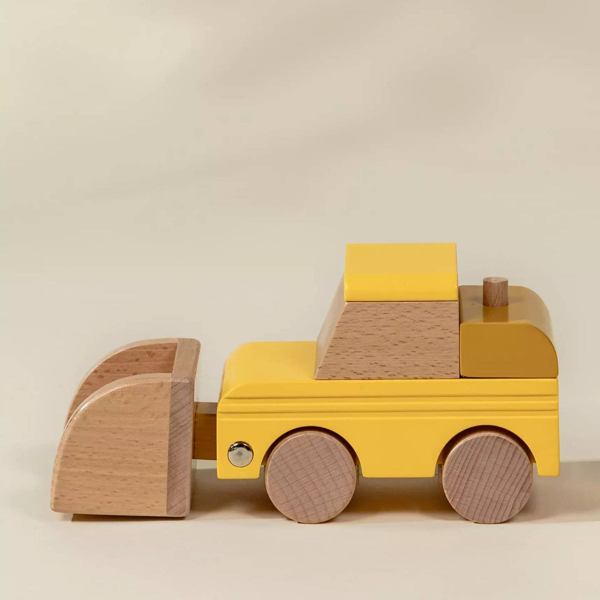 Wooden toy truck with a flatbed on a beige background