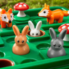 Toy animals including foxes, rabbits, and a mushroom on a green base.