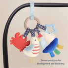 Baby toy with colorful textures on a beige background