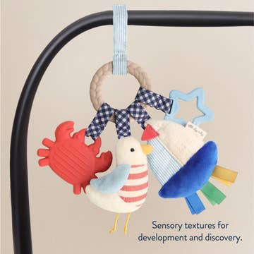 Baby toy with colorful textures on a beige background
