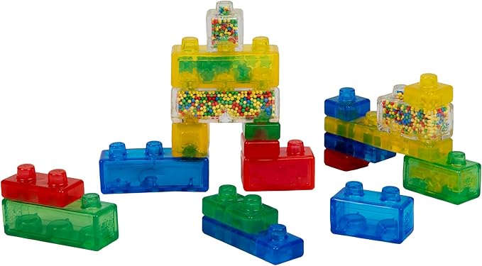 A collection of colorful, translucent Jelly Blox squishy building blocks assembled together, featuring standard bricks in red, blue, and green alongside special blocks filled with tiny colorful beads.
