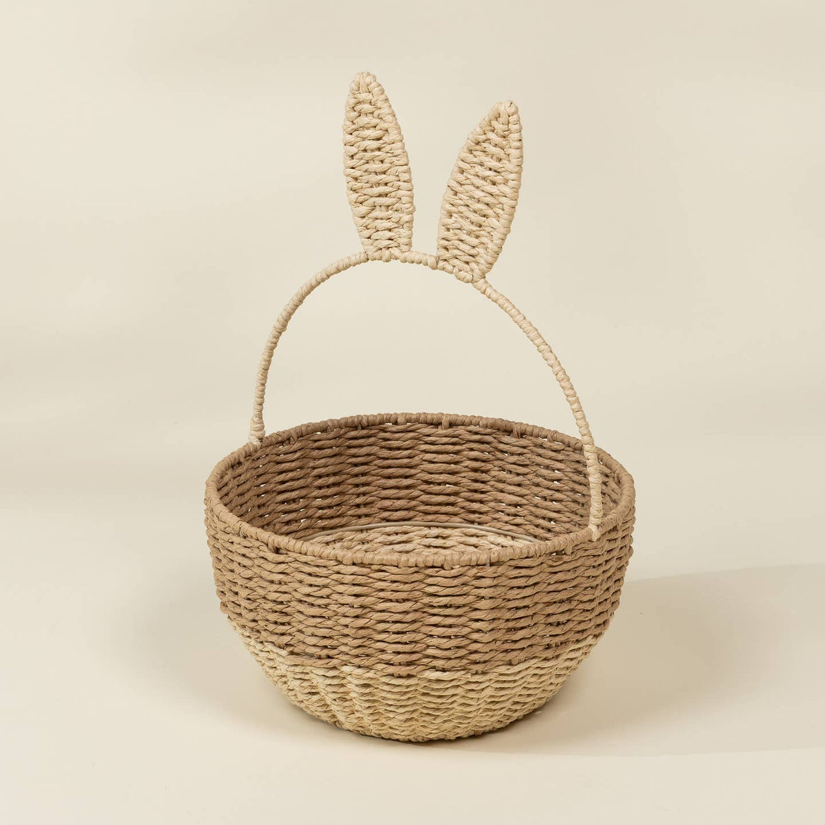 Woven basket with bunny ears on a beige background