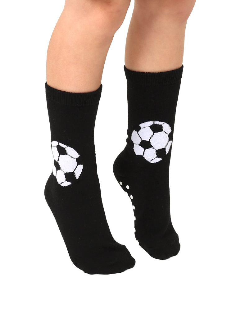 Black socks with white soccer ball designs worn by a person on a white background