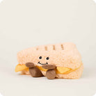 Plush toy resembling a sandwiche with a smiley face on a white background