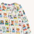 Children's long-sleeve shirt with colorful animal and furniture pattern on a white background
