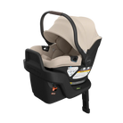 Baby car seat with beige cover and black base on a white background