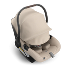Beige baby car seat with canopy on a white background