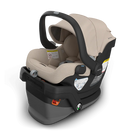 Baby car seat with beige interior and black exterior on a white background