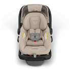 Beige car seat with black frame on a white background