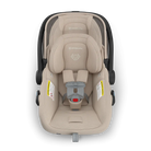 Beige baby car seat with black frame on a white background