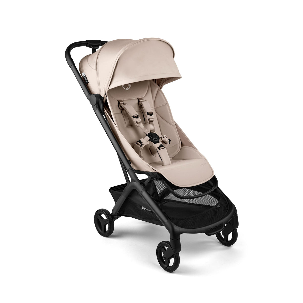 A compact stroller in a light beige/tan fabric with a black frame and wheels, shown from a three-quarter angle on a clean white background.