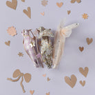 Three decorative items on a light purple background with heart shapes