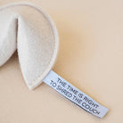 Textile product with a humorous label on a beige background