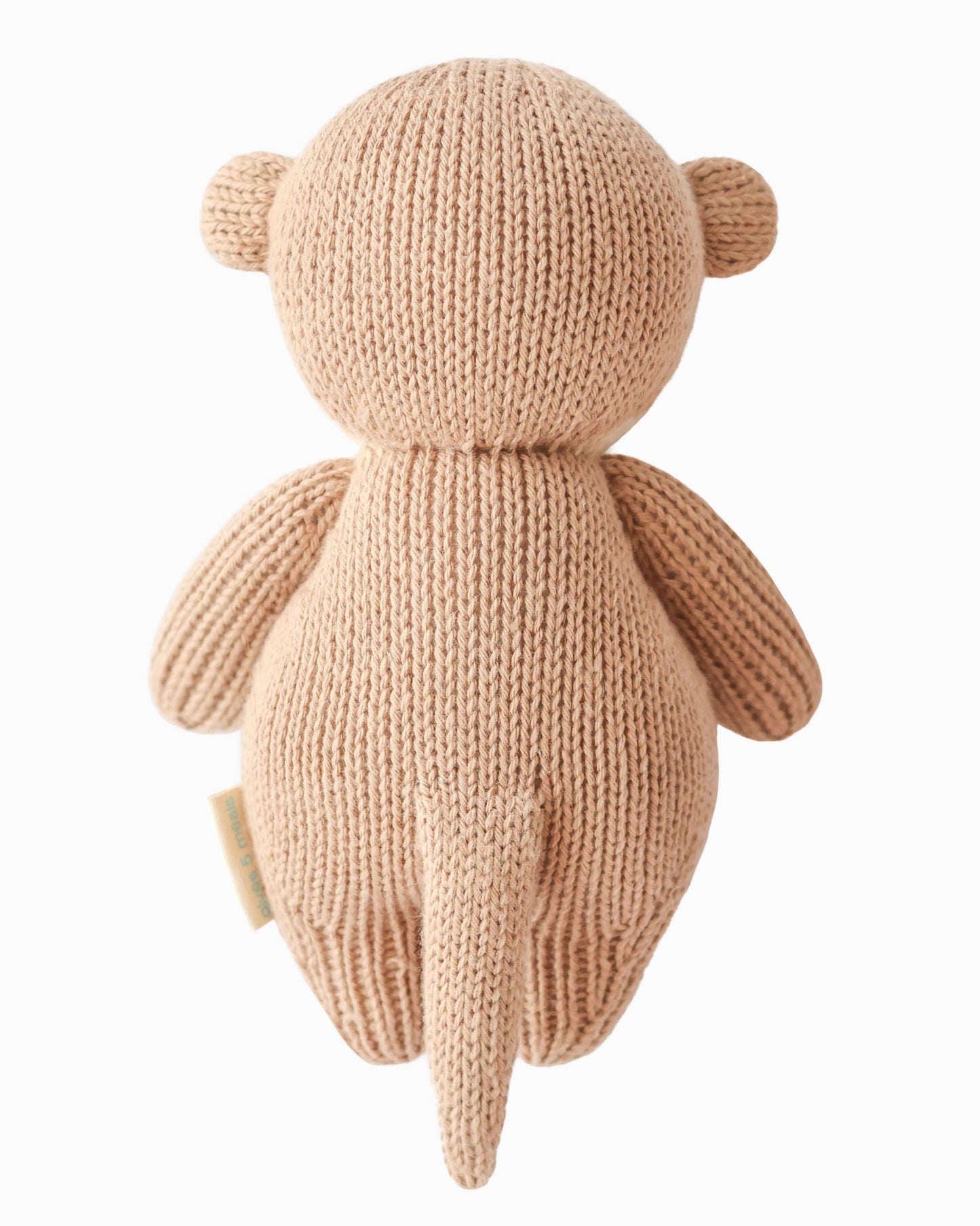 Knitted teddy bear toy on a white background