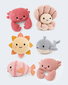 Six knitted plush toys arranged on a light gray background: a pink crab, a beige octopus, a yellow sun, a gray whale, a pink fish, and a pink crab.