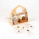 Wooden toy ice cream stand with animal figures on a white background