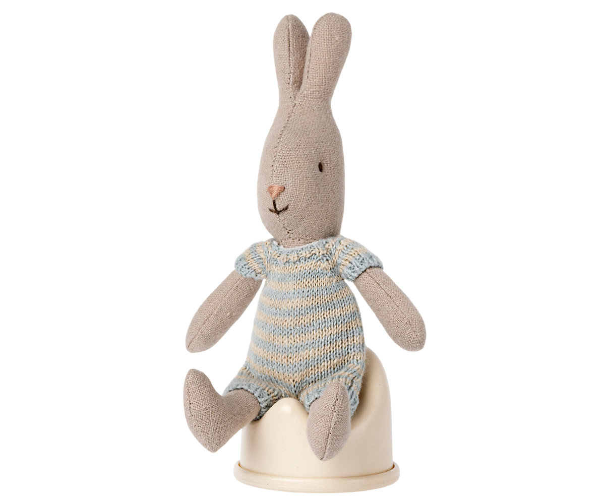 Stuffed rabbit toy with a striped sweater on a white background
