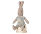 Stuffed rabbit toy with a striped sweater on a white background