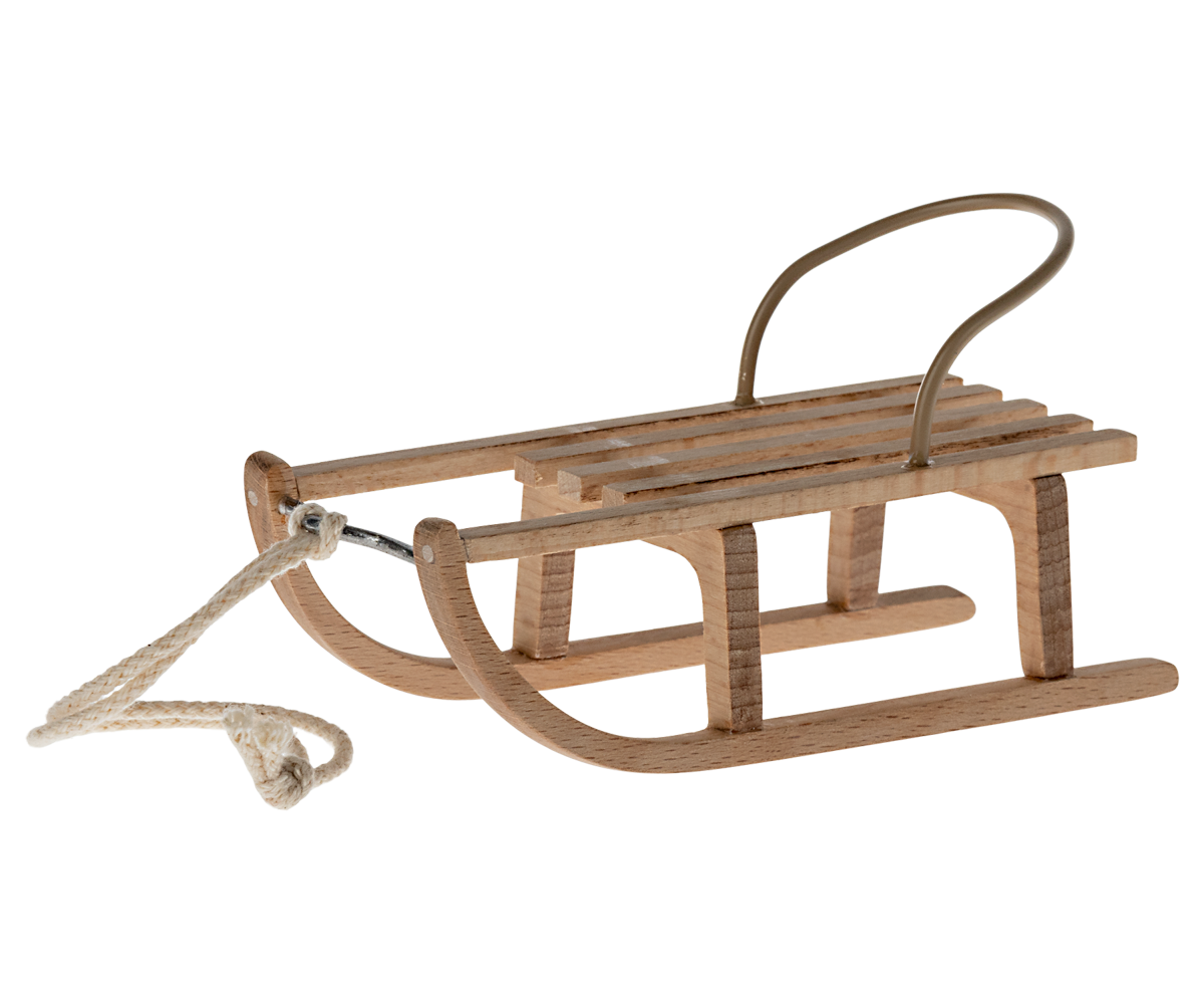Wooden sled with a rope on a white background