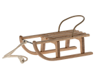 Wooden sled with a rope on a white background