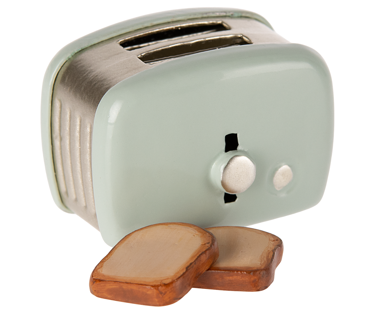 Small mint green toaster with wooden slices on a white background