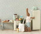 Stuffed toy rabbit opening a refrigerator in a playroom with toys and furniture.