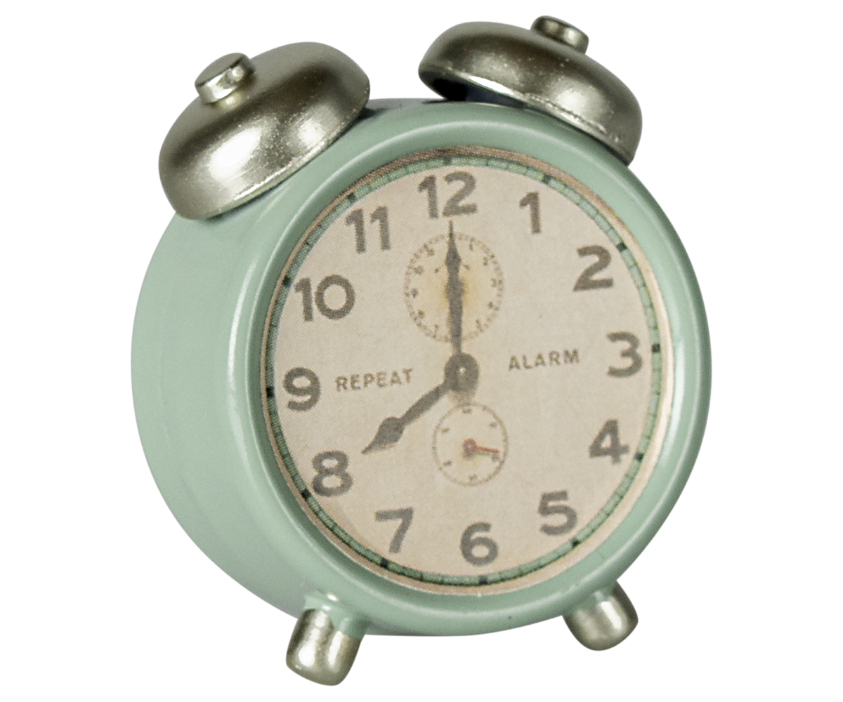 Vintage-style alarm clock with a light green body and silver accents on a white background