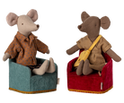 Two Maileg mouse figurines sitting in miniature upholstered armchairs—one in teal and one in red, wearing patterned shirts.