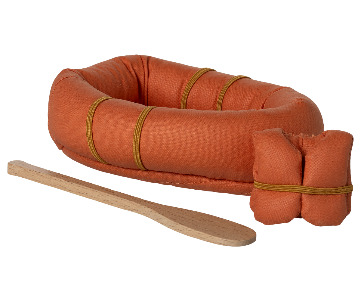 Orange inflatable raft with wooden oar on a white background